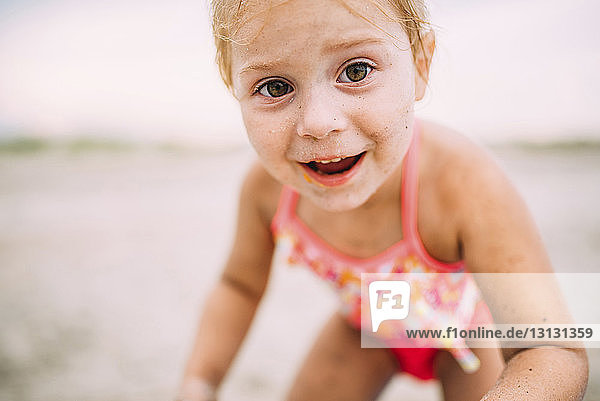 Portrait of happy girl standing at beach