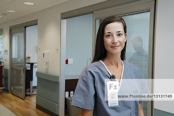 Portrait of confident nurse in hospital corridor
