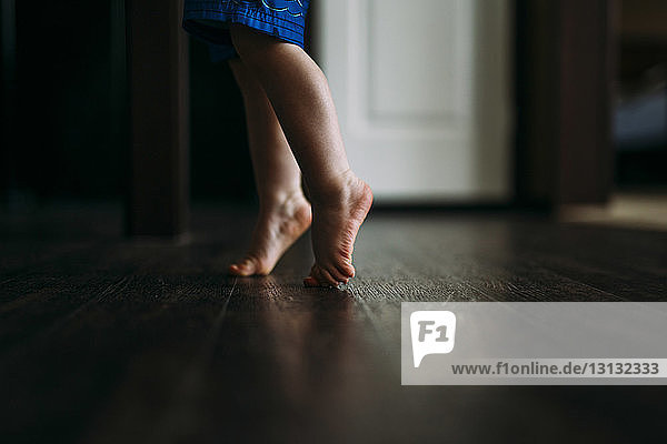 Low section of boy tiptoeing