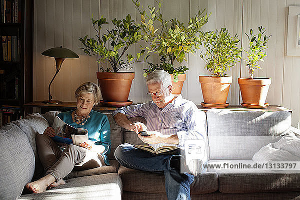 Senior couple sitting on sofa at home
