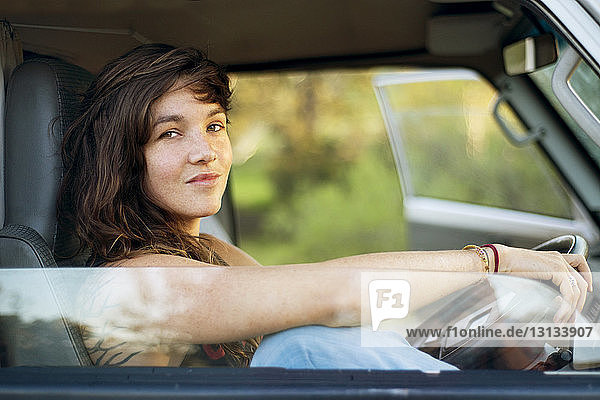 Portrait of confident woman sitting in van