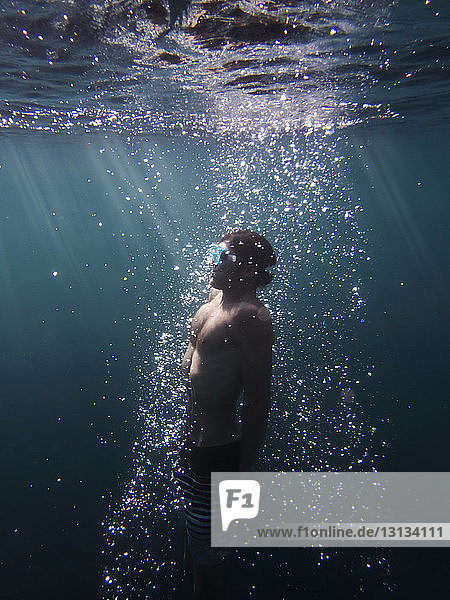 Side view of man swimming in sea