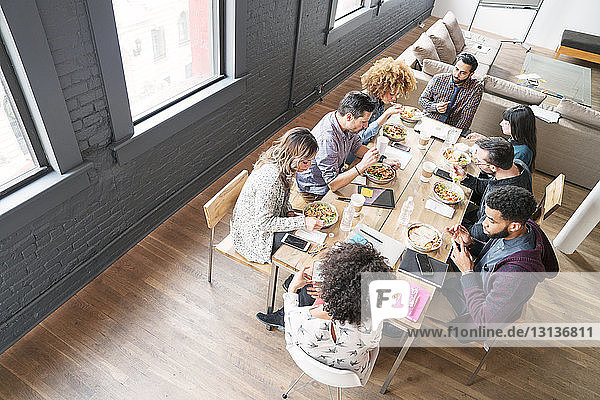 High angle view of business people having food in office