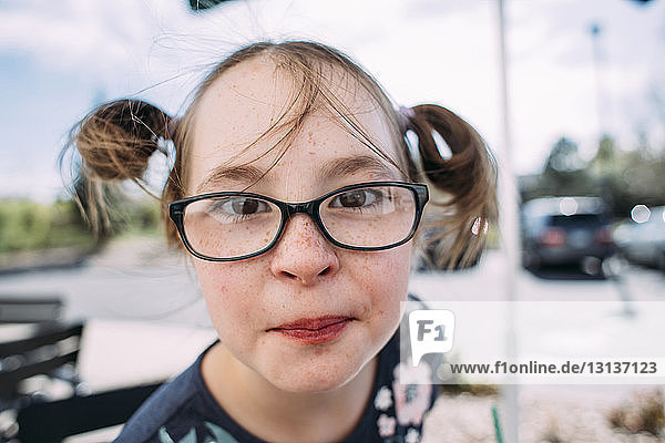 Portrait of girl in eyeglasses at sidewalk cafe