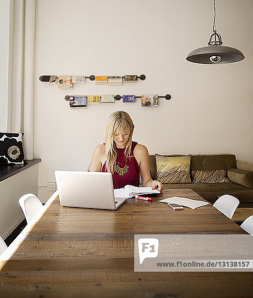 Businesswoman reading file in creative office