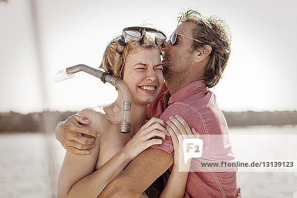 Close-up of happy couple embracing on boat