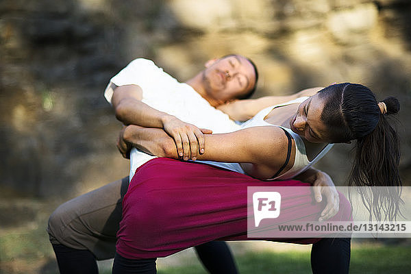 Affectionate couple embracing while practicing dance on field