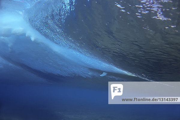 Surfboard underwater in sea at Maldives
