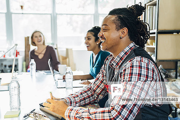 Happy business people at conference table