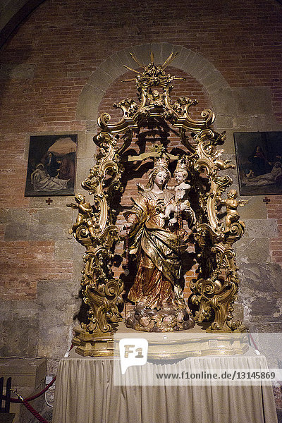 Italy Lombardy Pavia Basilica of San Michele Maggiore a medieval Romanesque church where Frederick I the Barbarossa was crowned King of Italy on April 17 1155. wooden statue of the Madonna del Rosario