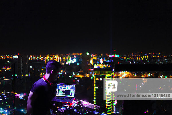 Vietnam  Ho Chi Minh City  Skyline at night  DJ in the foreground
