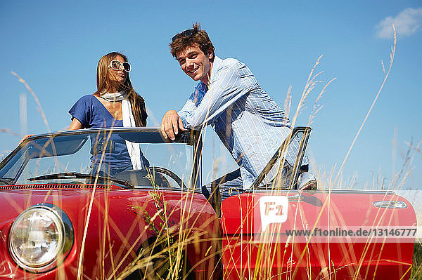 Couple in a red convertible