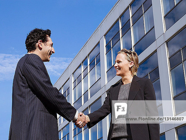 Business man & woman in front of office