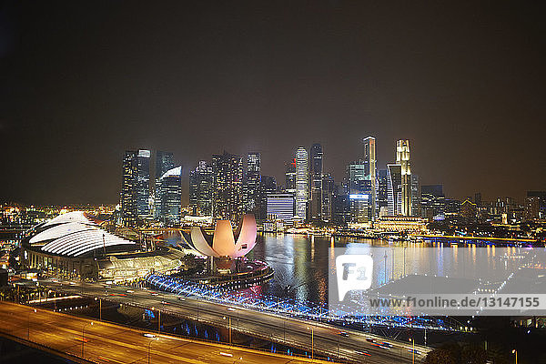 View of waterfront and skyscrapers at night  Singapore