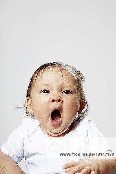 Portrait of baby girl yawning