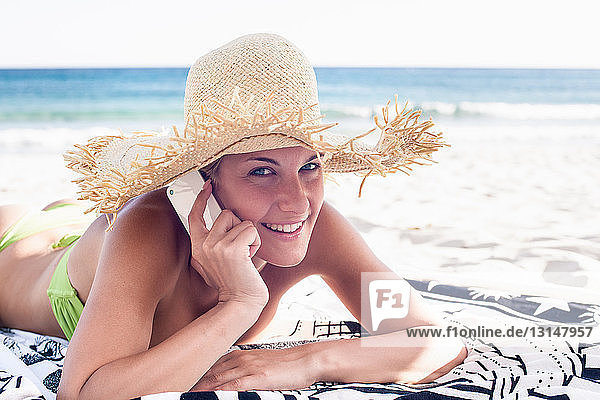 Woman talking on cell phone on beach