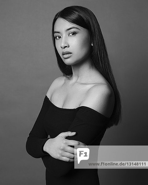 Portrait of young woman  looking at camera  studio shot