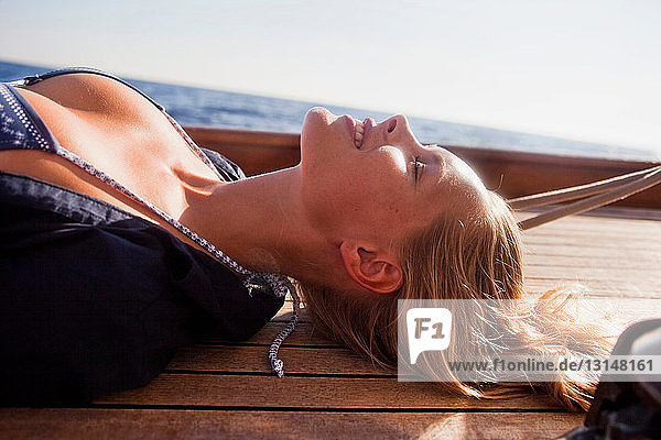 woman lying on deck eyes closed
