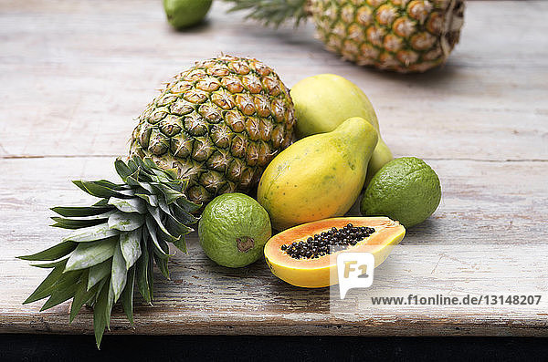 Fruit ingredients for tropical juice on wooden table