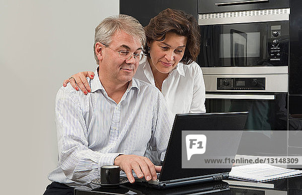 Mature couple looking at laptop