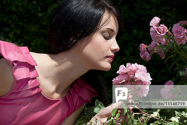Woman smelling flowers outdoors