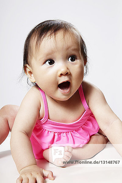 Portrait of baby girl looking surprised
