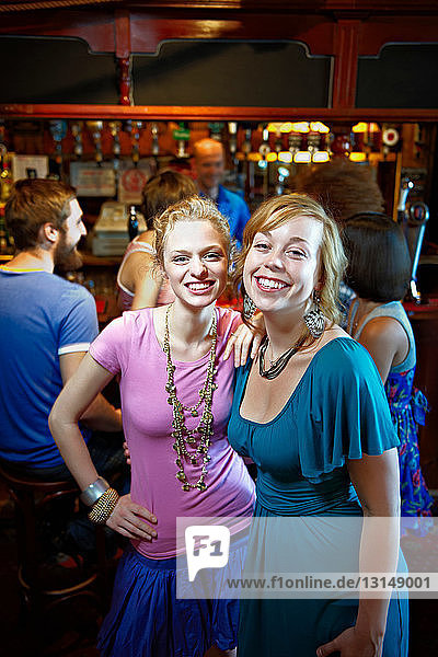 Junge Frauen posieren in einer Kneipe/Bar