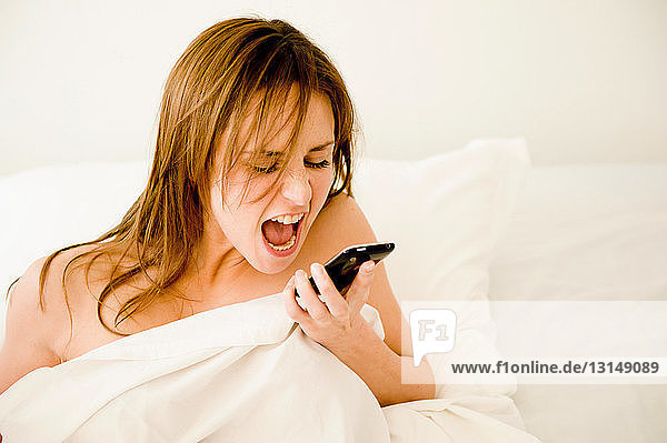 Young woman shouting at phone