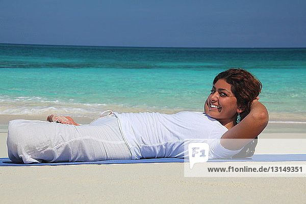 Young woman on beach practicing yoga  Paradise Island  Nassau  Bahamas