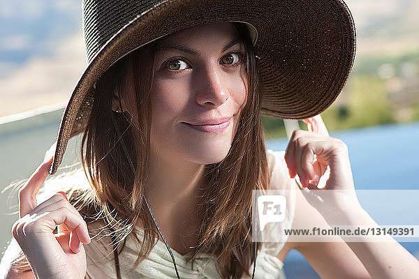 Smiling woman wearing hat outdoors