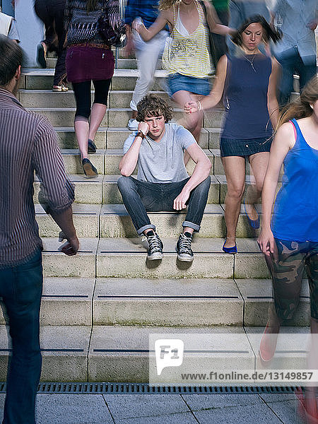 Portrait of lone young man in crowd