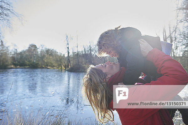 Mother lifting son in air  outdoors