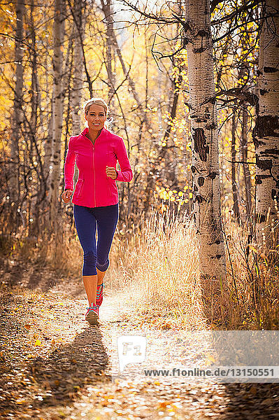 Woman jogging on dirt path
