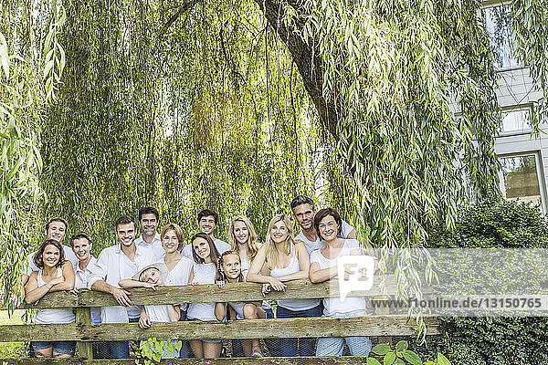 Portrait of group of people standing behind fence