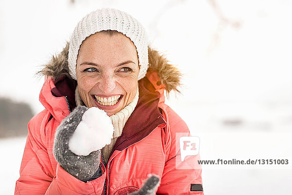 Woman holding snowball  laughing