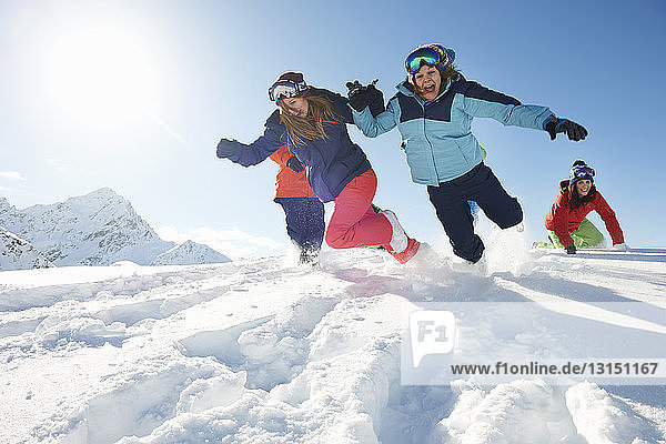 Friends running in snow  Kuhtai  Austria