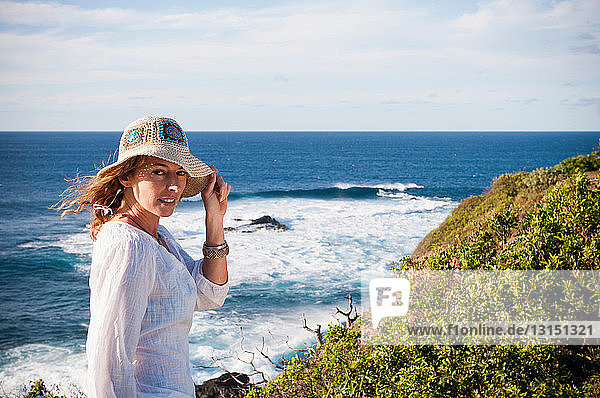 Woman standing on coastal cliffs
