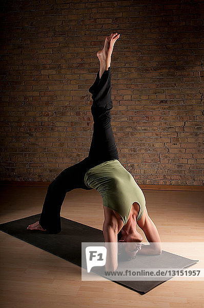 Woman practicing yoga on mat