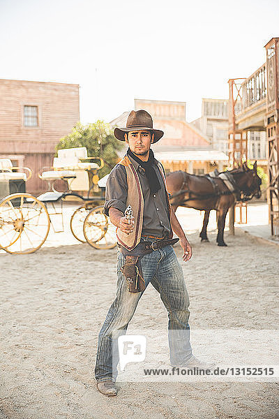 Portrait of cowboy pointing gun on wild west film set  Fort Bravo  Tabernas  Almeria  Spain