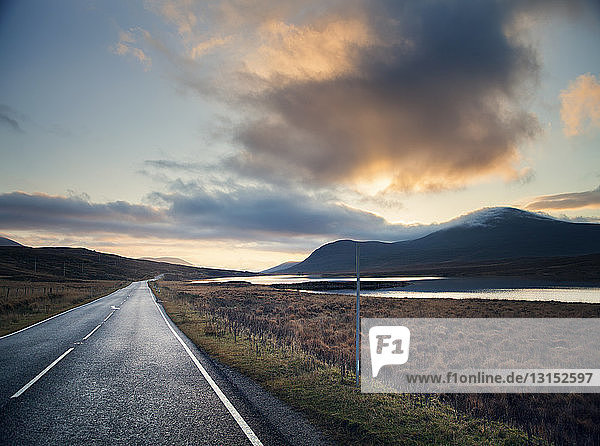 View of rural loch road at sunset  Assynt  North West Highlands  Scotland  UK