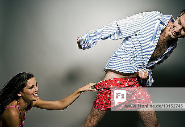 woman pulling man's underwear