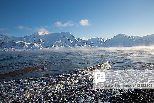 View of coast and distant mountains  Svalbard  Norway