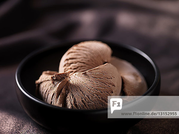 Chocolate ice cream in black ceramic bowl