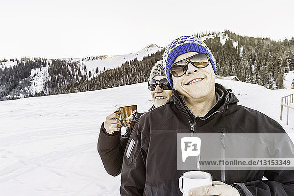 Friends enjoying coffee on snow-covered Achenkirch  Tirol  Austria