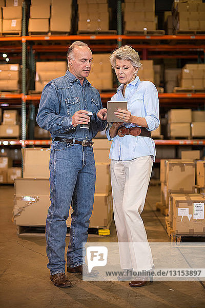 Warehouse workers using digital tablet