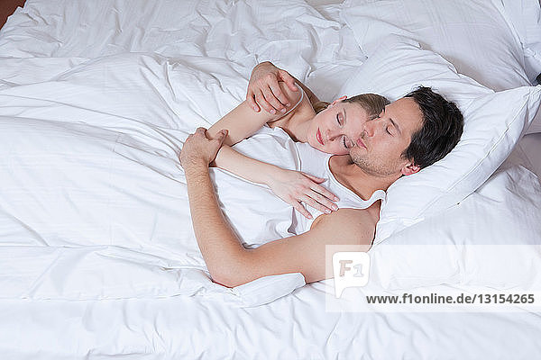 couple in bed  embraced  asleep