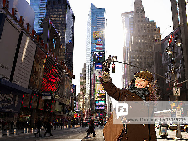 Woman with camera in Times Square