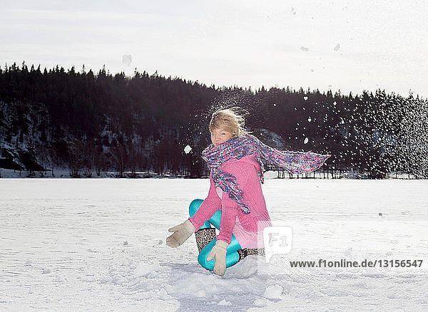 Girl throwing snow