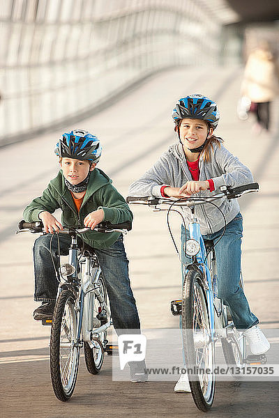 Children riding bicycles in city tunnel
