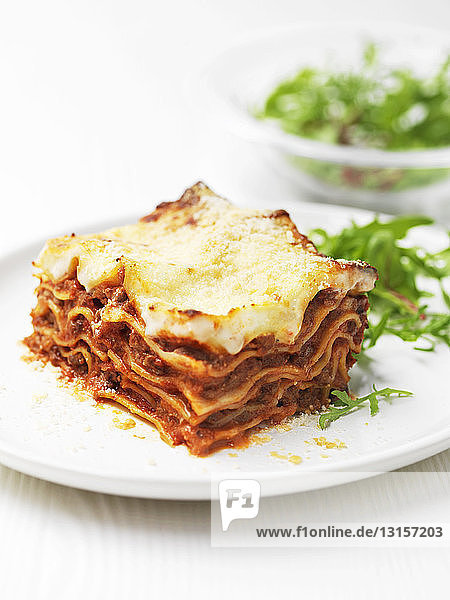 Plate of beef lasagna with salad leaves